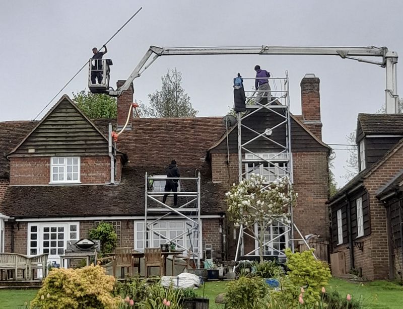 The Roof Moss Cleaners using cherry picker and scaffolding to clean roof safely and professionally in Caddington, Bedfordshire