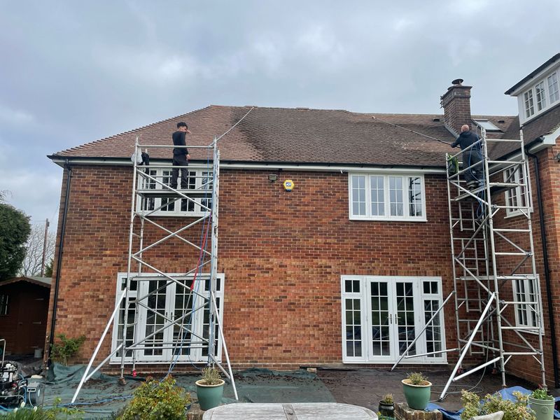 Roof cleaning carried out safely from scaffold towers by The Roof Moss Cleaners in Caddington